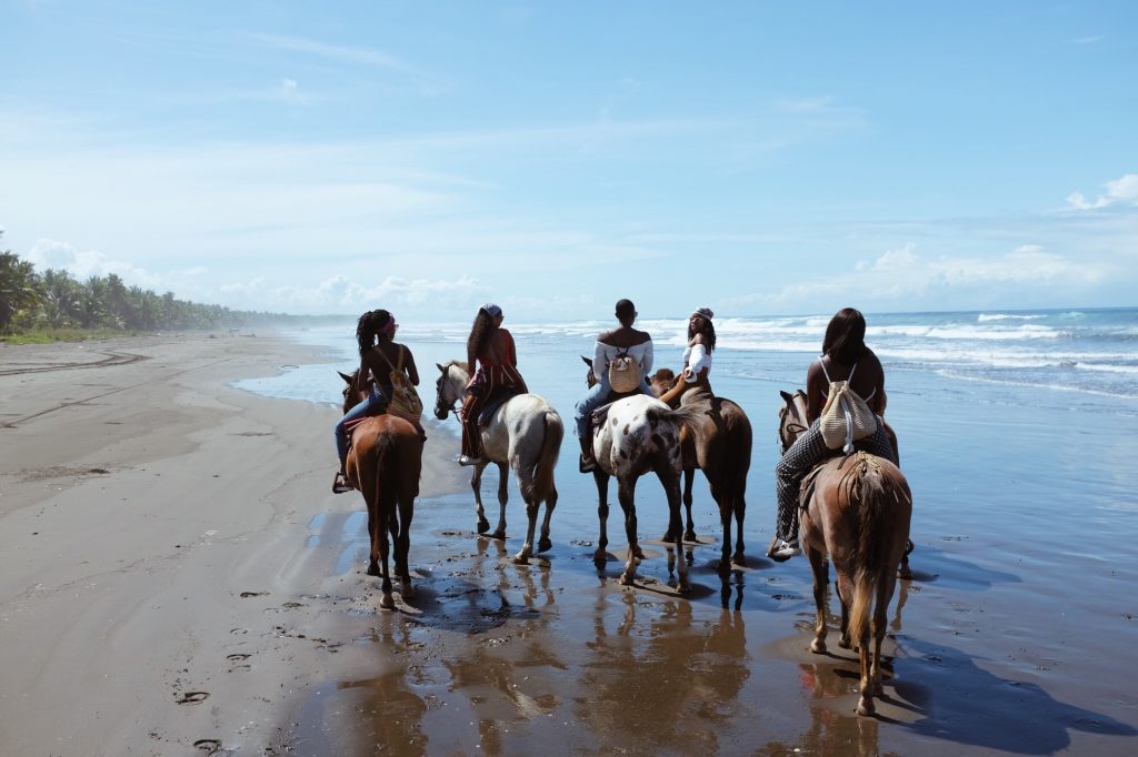Women riding horses on the beach 